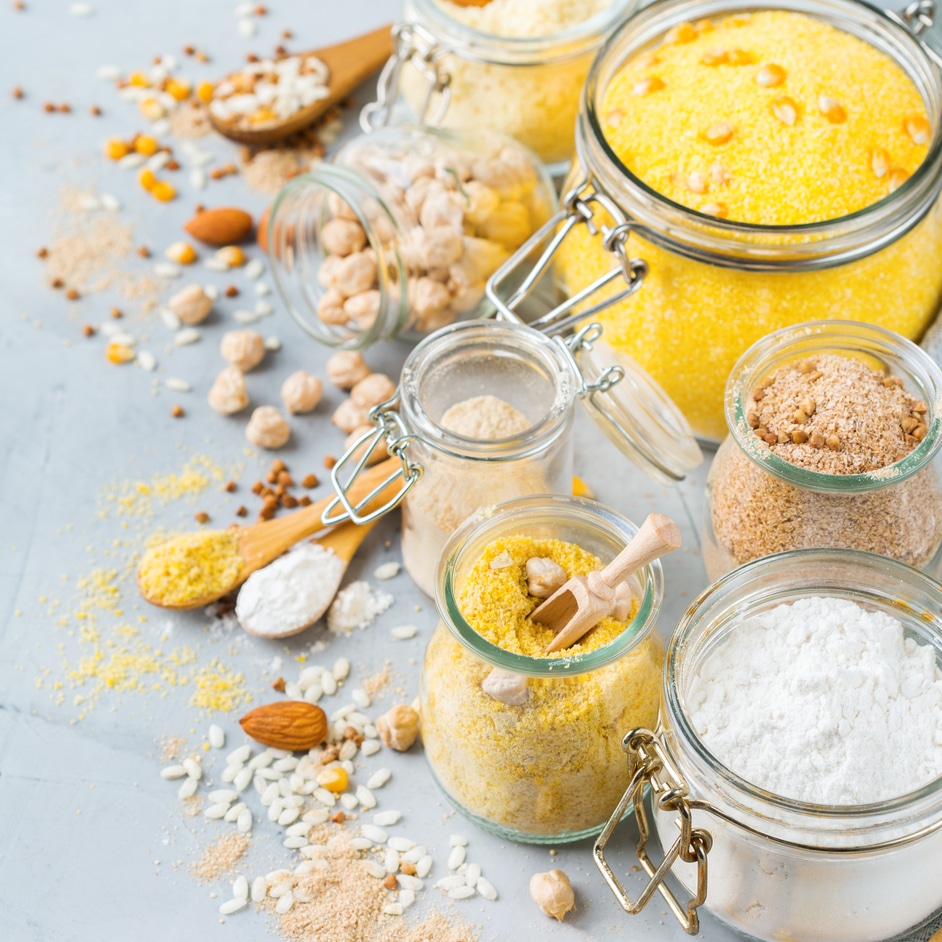 Healthy eating, dieting, balanced food concept. Assortment of gluten free flour, almond, corn, rice on a kitchen table.