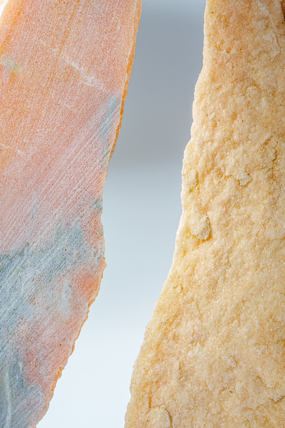 Two granite stones on gray background close up photo